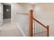 Upstairs hallway with wood staircase and neutral carpeting at 184 Valencia Cir, St Petersburg, FL 33716