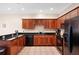 Modern kitchen with dark wood cabinets and black appliances at 184 Valencia Cir, St Petersburg, FL 33716