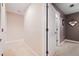A well-lit hallway with carpeted floors and access to other rooms at 184 Valencia Cir, St Petersburg, FL 33716