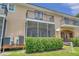 Townhome exterior with lush landscaping and screened porch at 184 Valencia Cir, St Petersburg, FL 33716