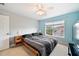 Bedroom with a large bed, ceiling fan, and large window at 184 Valencia Cir, St Petersburg, FL 33716