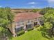 Back exterior of townhouse with balconies, screened porch, and a grassy yard at 184 Valencia Cir, St Petersburg, FL 33716