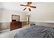 Bedroom with a dresser and king-size bed, near a bathroom at 184 Valencia Cir, St Petersburg, FL 33716