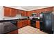 Modern kitchen with dark wood cabinets and black appliances at 184 Valencia Cir, St Petersburg, FL 33716