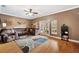 Living room with brown couches, ceiling fan, and access to a balcony at 184 Valencia Cir, St Petersburg, FL 33716
