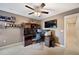 Bright bedroom with a workspace, large TV and ceiling fan at 184 Valencia Cir, St Petersburg, FL 33716