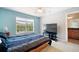 Bedroom with a large bed, TV, and access to bathroom at 184 Valencia Cir, St Petersburg, FL 33716