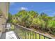 Private balcony with a view of the backyard and surrounding trees at 184 Valencia Cir, St Petersburg, FL 33716