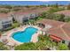 Community pool with surrounding patio and lounge chairs at 184 Valencia Cir, St Petersburg, FL 33716
