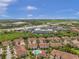 Aerial view of townhouses and community pool with a highway in the distance at 184 Valencia Cir, St Petersburg, FL 33716