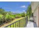 Private balcony overlooking lush greenery and a distant building at 184 Valencia Cir, St Petersburg, FL 33716