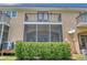 Rear view of townhome showcasing screened porch and balcony at 184 Valencia Cir, St Petersburg, FL 33716