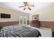 King-size bedroom with a dresser, a TV, and balcony access at 184 Valencia Cir, St Petersburg, FL 33716