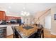 Open concept kitchen and dining area with dark wood cabinets and a unique table at 184 Valencia Cir, St Petersburg, FL 33716