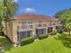 Back exterior of light beige townhouse with balconies and screened porch at 184 Valencia Cir, St Petersburg, FL 33716