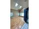 Spacious living room featuring skylights and laminate flooring at 4031 Quail Briar Dr, Valrico, FL 33596
