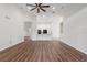 Spacious living room with wood-look floors and ceiling fan at 31421 Anniston Dr, Wesley Chapel, FL 33543