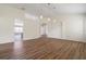 Open concept living room with hardwood flooring and high ceilings at 31421 Anniston Dr, Wesley Chapel, FL 33543