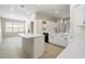 Modern kitchen with white cabinets, island and quartz countertops at 31421 Anniston Dr, Wesley Chapel, FL 33543
