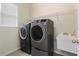 Laundry room with washer, dryer, and utility sink at 31421 Anniston Dr, Wesley Chapel, FL 33543