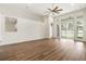 Bright living room, wood-look floors, sliding doors to patio at 31421 Anniston Dr, Wesley Chapel, FL 33543