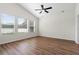 Bright bedroom with wood-look floors and multiple windows at 31421 Anniston Dr, Wesley Chapel, FL 33543