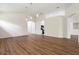 Open living room with hardwood floors and views to kitchen and entry at 31421 Anniston Dr, Wesley Chapel, FL 33543
