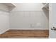Large walk-in closet with wire shelving and wood-look floors at 31421 Anniston Dr, Wesley Chapel, FL 33543