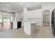 Open kitchen with white cabinets, large island and access to Gathering room at 31421 Anniston Dr, Wesley Chapel, FL 33543