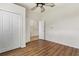 Well-lit bedroom with wood-look floors and double door closet at 31421 Anniston Dr, Wesley Chapel, FL 33543