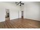 Main bedroom with wood floors and access to en-suite bathroom at 31421 Anniston Dr, Wesley Chapel, FL 33543