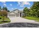 Two-story house with three-car garage and landscaping at 31421 Anniston Dr, Wesley Chapel, FL 33543