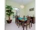 Bright dining room featuring a wood table and six chairs at 17812 Arbor Greene Dr, Tampa, FL 33647