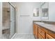 Clean bathroom with shower and wood vanity at 37700 Neukom Ave, Zephyrhills, FL 33541