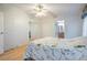 Bedroom with mirrored closet doors, light wood flooring, and floral wallpaper at 37700 Neukom Ave, Zephyrhills, FL 33541