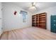 Bedroom with built-in shelving and wood flooring at 37700 Neukom Ave, Zephyrhills, FL 33541