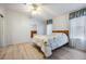 Bedroom with double bed, light wood flooring, and patterned wallpaper at 37700 Neukom Ave, Zephyrhills, FL 33541