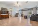Spacious living room with light wood floors and a ceiling fan at 37700 Neukom Ave, Zephyrhills, FL 33541