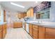 Bright kitchen with light wood cabinets and vinyl flooring at 37700 Neukom Ave, Zephyrhills, FL 33541
