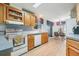 Bright kitchen with ample cabinetry and wood flooring at 37700 Neukom Ave, Zephyrhills, FL 33541