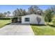 Single story home with covered carport and manicured lawn at 37700 Neukom Ave, Zephyrhills, FL 33541