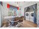 Small dining area with table and chairs, washer and dryer tucked behind curtains at 37700 Neukom Ave, Zephyrhills, FL 33541
