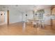 Dining area with wood-look floors and a glass table at 37700 Neukom Ave, Zephyrhills, FL 33541