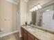 Bathroom features a granite countertop, tile floors, and neutral paint at 13216 Legends Trl, Dade City, FL 33525