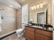 Bathroom featuring a shower, dark countertops and light fixtures at 13216 Legends Trl, Dade City, FL 33525