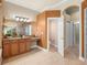 Bathroom featuring granite counters on the vanity area and a glass block shower at 13216 Legends Trl, Dade City, FL 33525