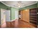 Bedroom featuring hardwood floors, a ceiling fan and a built in murphy bed at 13216 Legends Trl, Dade City, FL 33525