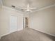 Bedroom featuring carpet, a ceiling fan and a view to the hallway at 13216 Legends Trl, Dade City, FL 33525