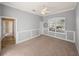 Spacious bedroom with neutral walls and carpeted floors bathed in natural light at 13216 Legends Trl, Dade City, FL 33525