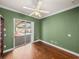 Bedroom featuring hardwood floors, a ceiling fan and access to the pool at 13216 Legends Trl, Dade City, FL 33525